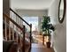 Entryway staircase with wood floors and a view of the front window at 5821 Saint Miles Dr, Buford, GA 30518