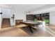 Finished basement offers a pool table, fireplace, large screen and wooden staircase at 2716 Ridgewood Nw Rd, Atlanta, GA 30327