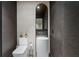 Stylish powder room features a pedestal sink, modern fixtures, and dark textured wallpaper at 2716 Ridgewood Nw Rd, Atlanta, GA 30327