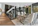 Dining area boasts modern lighting, glass table, plush rug, and views of the surrounding nature at 2716 Ridgewood Nw Rd, Atlanta, GA 30327