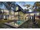 Stunning modern home with a pool, lounge chairs, and large windows offering picturesque views at 2716 Ridgewood Nw Rd, Atlanta, GA 30327