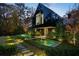 Modern home with sleek black exterior, water feature, and lush landscaping at 2716 Ridgewood Nw Rd, Atlanta, GA 30327