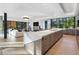 Open kitchen layout boasts large island, wood cabinets and hardwood floors, flowing into living area at 2716 Ridgewood Nw Rd, Atlanta, GA 30327
