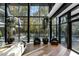 Stunning living area with floor-to-ceiling windows overlooking the outdoor pool and lush greenery at 2716 Ridgewood Nw Rd, Atlanta, GA 30327