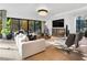 Sophisticated living room with fireplace, hardwood floors and sliding glass doors to exterior at 2716 Ridgewood Nw Rd, Atlanta, GA 30327