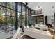 Bright living room with floor-to-ceiling windows, modern staircase, and view of the outdoor pool at 2716 Ridgewood Nw Rd, Atlanta, GA 30327