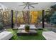 Outdoor patio with seating, lush landscaping, and serene wooded views, with artificial grass at 2716 Ridgewood Nw Rd, Atlanta, GA 30327