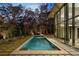 Serene pool area with lounge chairs and mature trees offering a private and luxurious retreat at 2716 Ridgewood Nw Rd, Atlanta, GA 30327