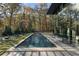 Outdoor pool area surrounded by lush landscaping and manicured grounds with lounge seating at 2716 Ridgewood Nw Rd, Atlanta, GA 30327