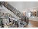 Elegant staircase with open railing overlooking the living area and large windows at 2716 Ridgewood Nw Rd, Atlanta, GA 30327