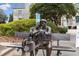 Bronze statue of elderly couple sitting on a park bench at 315 W Benson St, Decatur, GA 30030