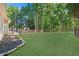 Large backyard featuring a level lawn and a wood fence, backing up to woods at 7802 Bamby Rd, Cumming, GA 30041