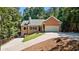 Charming brick home with a two-car garage and well-manicured lawn on a sunny day at 7802 Bamby Rd, Cumming, GA 30041