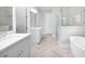 Elegant bathroom with double vanity, soaking tub, and herringbone tile at 3909 Collarton Close Se, Smyrna, GA 30080