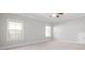 Bright bedroom featuring carpet, ceiling fan and two large windows at 3909 Collarton Close Se, Smyrna, GA 30080