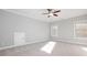 Spacious bedroom with carpet, ceiling fan, and ample natural light at 3909 Collarton Close Se, Smyrna, GA 30080
