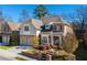 Two-story house with a brick facade, two-car garage, and manicured landscaping at 3909 Collarton Close Se, Smyrna, GA 30080