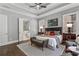 Main bedroom with king-size bed, hardwood floors, and ensuite bathroom at 3909 Collarton Close Se, Smyrna, GA 30080