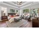 Main bedroom with king-size bed, hardwood floors, and sitting area at 3909 Collarton Close Se, Smyrna, GA 30080