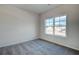 Spacious bedroom featuring grey carpet and a large window with a neighborhood view at 606 Somerset Ct, Loganville, GA 30052