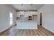 Modern kitchen with white cabinets, granite island, and hardwood floors at 606 Somerset Ct, Loganville, GA 30052