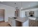 Island kitchen with white cabinets, granite countertops and stainless steel sink at 606 Somerset Ct, Loganville, GA 30052