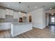 Modern kitchen with white cabinets, granite countertops and hardwood floors at 606 Somerset Ct, Loganville, GA 30052