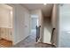 Upstairs hallway with carpet, railing, and access to bedrooms and bathroom at 606 Somerset Ct, Loganville, GA 30052