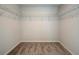 Bright walk-in closet with wire shelving and carpet flooring at 606 Somerset Ct, Loganville, GA 30052