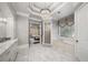 Spa-like bathroom featuring a soaking tub, walk-in shower, and marble floors at 12710 Old Surrey Pl, Roswell, GA 30075