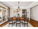 Elegant dining room with hardwood floors and a live edge dining table at 12710 Old Surrey Pl, Roswell, GA 30075