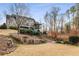 House exterior with stonework and tiered landscaping at 12710 Old Surrey Pl, Roswell, GA 30075