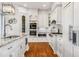 Elegant kitchen with white cabinets, granite countertops, and high-end appliances at 12710 Old Surrey Pl, Roswell, GA 30075