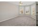 Bright bedroom with neutral walls and carpet, featuring a bay window and ceiling fan at 3830 High Point Cir, Cumming, GA 30041