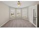 Spacious bedroom with neutral walls and carpet, featuring a bay window and ceiling fan at 3830 High Point Cir, Cumming, GA 30041