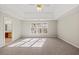 Main bedroom with high ceilings, large windows, and neutral decor at 3830 High Point Cir, Cumming, GA 30041