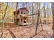 Rustic two-story home nestled in a wooded setting with a swing set at 3830 High Point Cir, Cumming, GA 30041