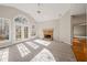 Bright Gathering room featuring a fireplace and large windows at 3830 High Point Cir, Cumming, GA 30041