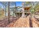 Two story house with deck and covered porch in wooded setting at 3830 High Point Cir, Cumming, GA 30041