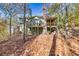 Two story house with deck and covered porch in wooded setting at 3830 High Point Cir, Cumming, GA 30041