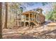 Two-story house with deck, porch, and walkway, nestled in woods at 3830 High Point Cir, Cumming, GA 30041