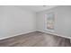 Simple bedroom with large window and wood-look floors at 3193 Deshong Dr, Stone Mountain, GA 30087