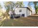 White house exterior with a deck and surrounding trees at 3193 Deshong Dr, Stone Mountain, GA 30087