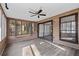 Bright sunroom with wood-paneled walls and ceiling fan at 3193 Deshong Dr, Stone Mountain, GA 30087