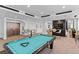 Entertainment area with a billiard table, lounge seating, and modern lighting at 855 Peachtree St # 2205, Atlanta, GA 30308
