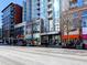 Street view of a modern building, showcasing nearby shops and restaurants, with easy access at 855 Peachtree St # 2205, Atlanta, GA 30308