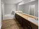 Bathroom featuring double sink vanity, a tub, and wood-look flooring at 3279 Wild Basil Ln, Buford, GA 30519