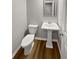 Powder room featuring pedestal sink, wood-look flooring and modern toilet at 3279 Wild Basil Ln, Buford, GA 30519
