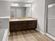 Well-lit bathroom featuring double vanity, walk-in shower, and tile flooring at 3279 Wild Basil Ln, Buford, GA 30519
