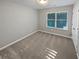 Bedroom featuring neutral carpet, a window with blinds, and gray walls providing a serene space at 3279 Wild Basil Ln, Buford, GA 30519